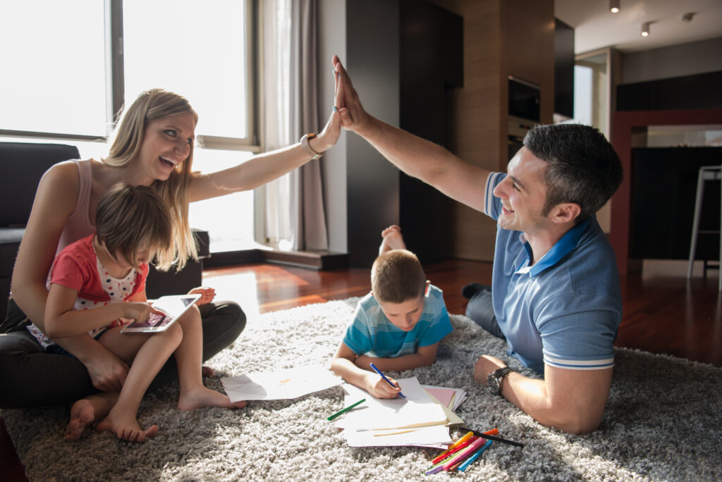 family high fiving one another strive for a low-stress school year