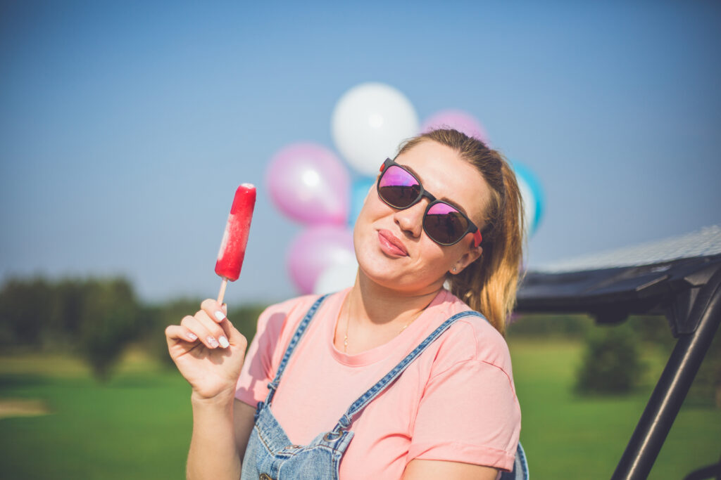 Woman staying cool by eating popsicle