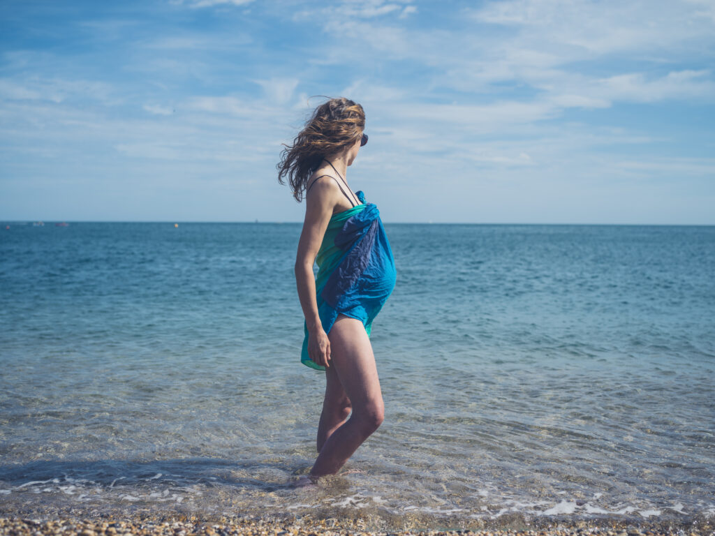 Pregnant woman at beach.