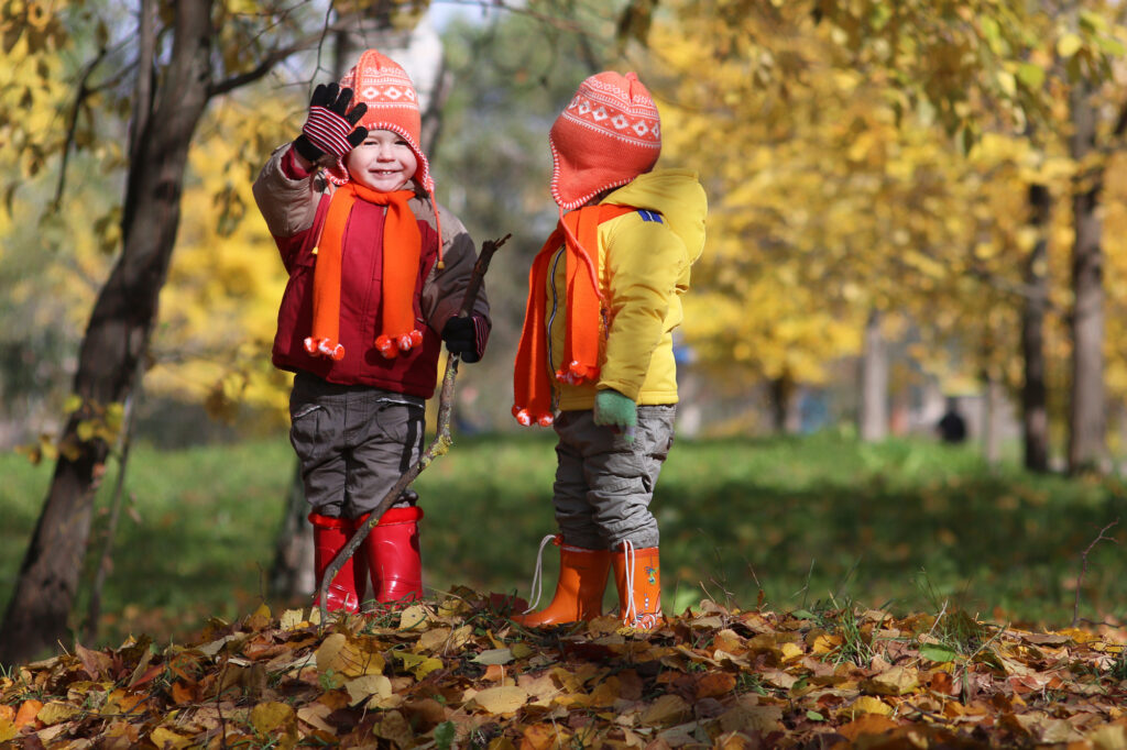 Young kids taking a walk in the fall