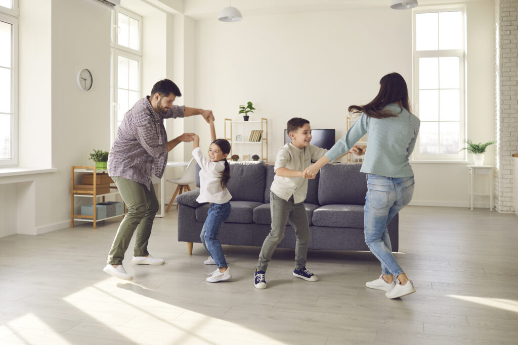 Family dancing in living room together