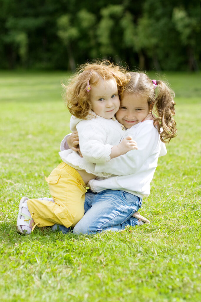 two young kids hugging one another