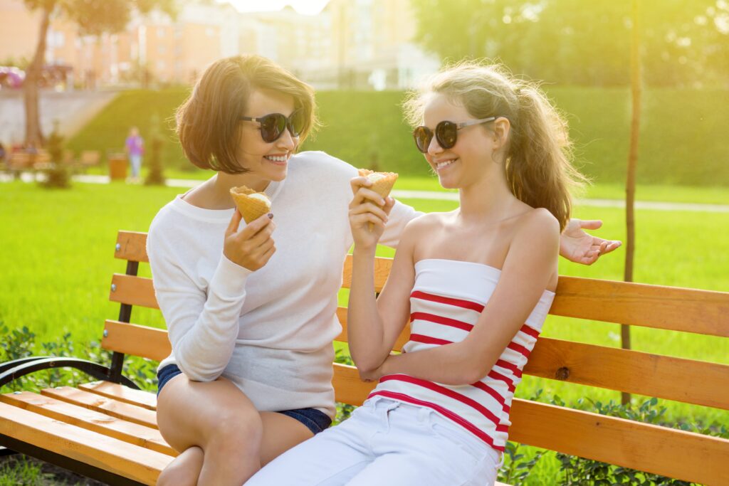 Mom and teen daughter having ice cream together