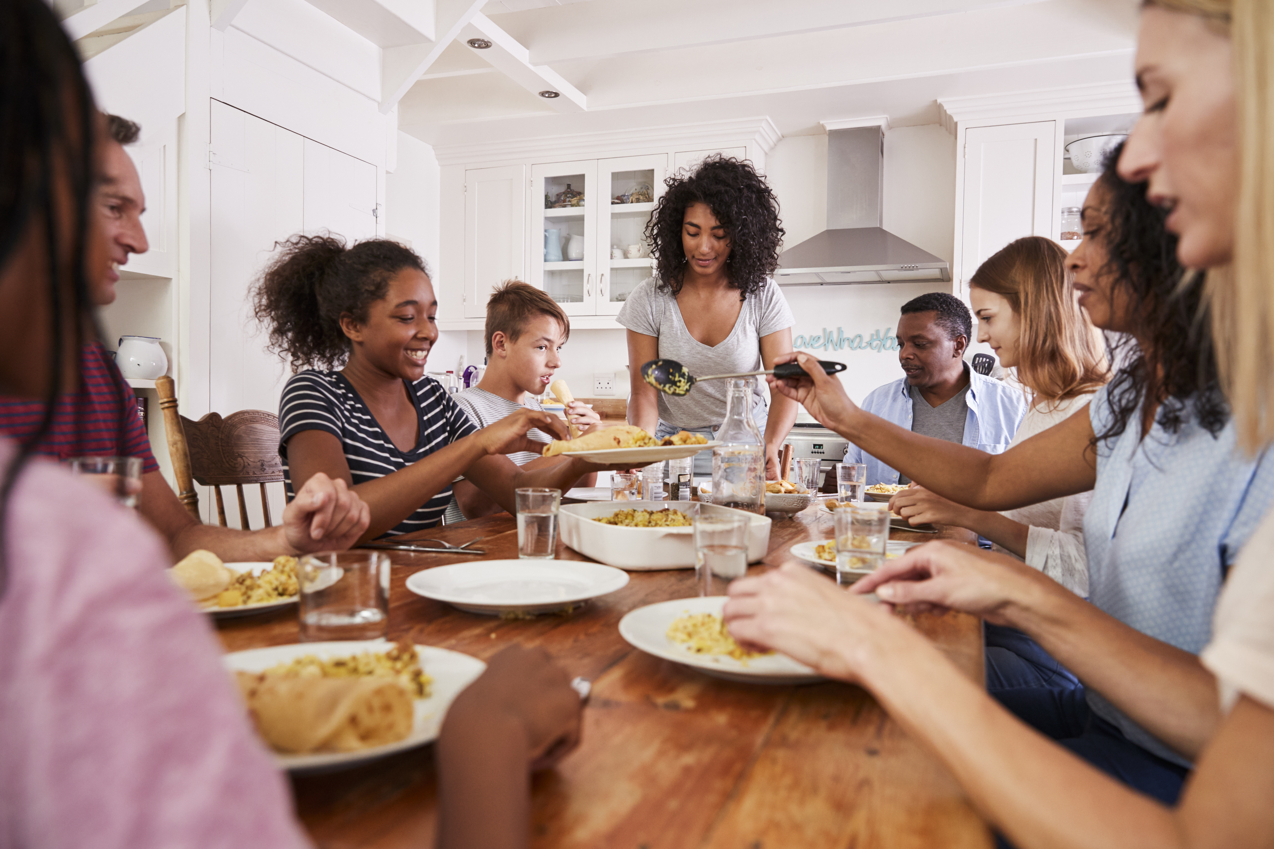 African American family enjoying dinner together.