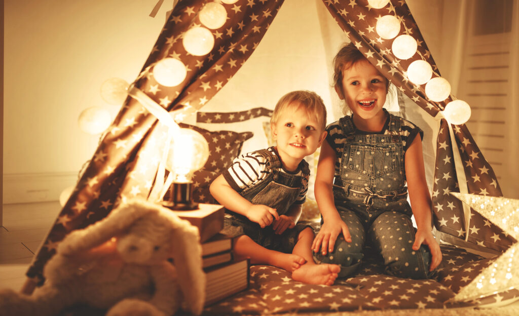 kids have cute fort under the stairs