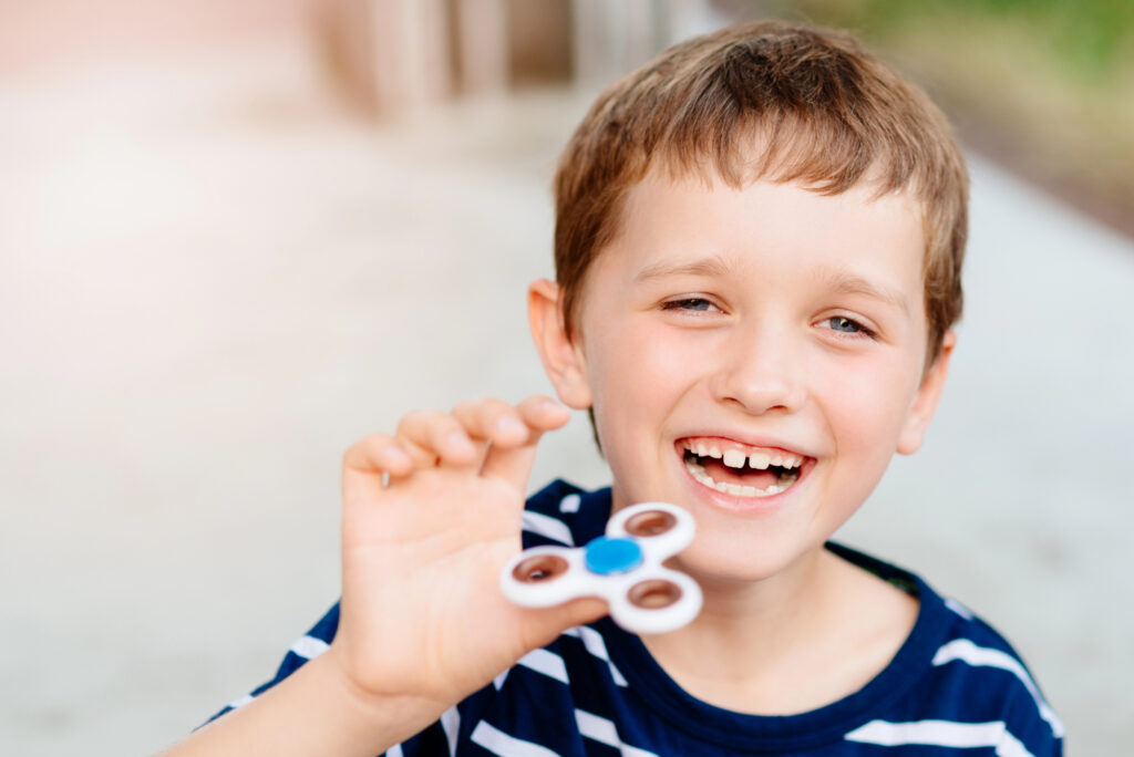 Boy relieves stress with a fidget toy.