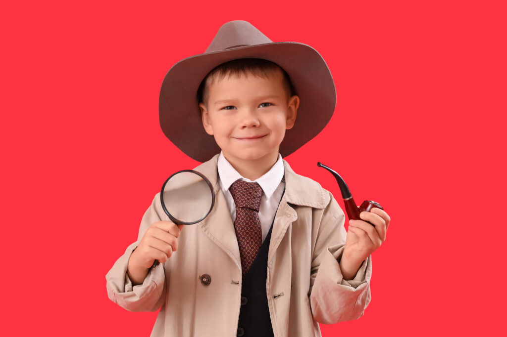 Young boy playing detective.